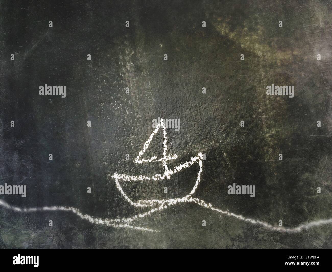 Little sailboat on a Wave drawn on a blackboard with chalk - Smartphone Captured Stock Image