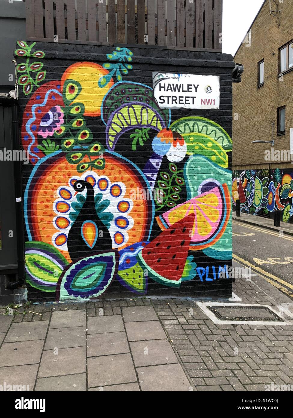 Street art on two walls in Hawley street in Camden Town in London Stock Photo
