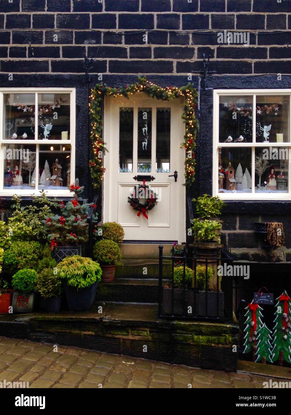 House with Christmas decorations including a wreath on the door - Smartphone Captured Stock Image