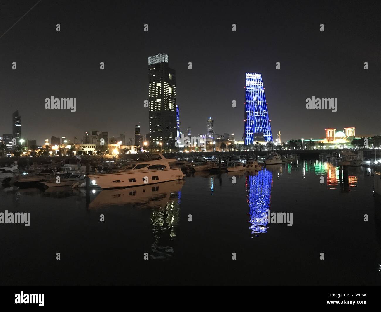 Souk Sharq marina reflecting city lights... Stock Photo