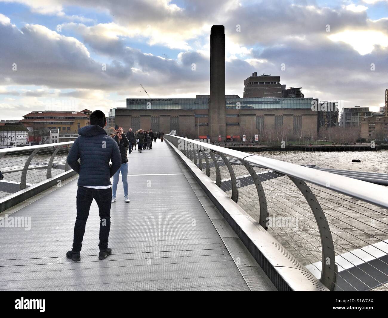 People walk across the London Millennium Footbridge in London, England on January 4 2018 - Smartphone Captured Stock Image