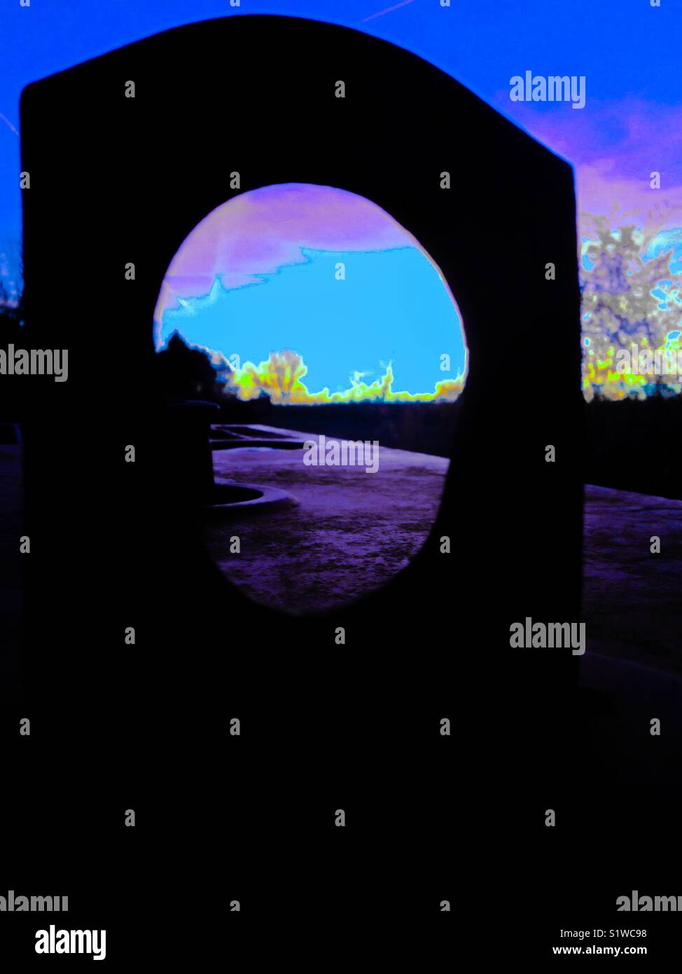 Blue sunset through lifting eye of farm welding machine - Smartphone Captured Stock Image