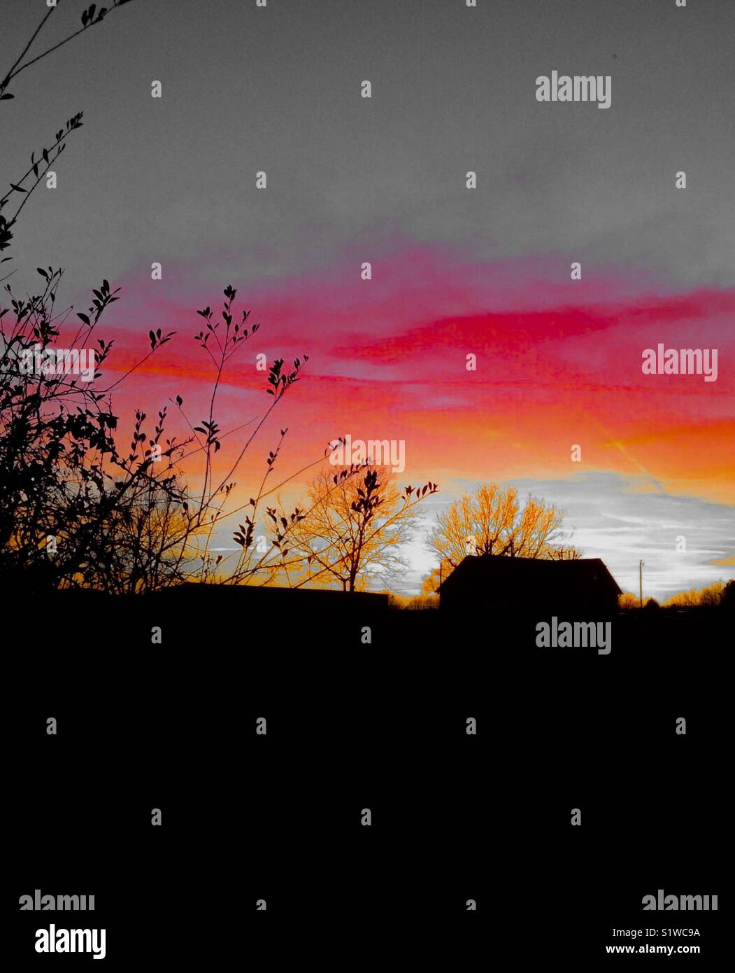 Farmhouse silhouette in rural sunset - Smartphone Captured Stock Image