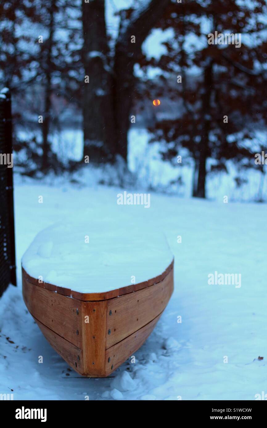 A boat shaped bench in a park during winter Stock Photo - Alamy