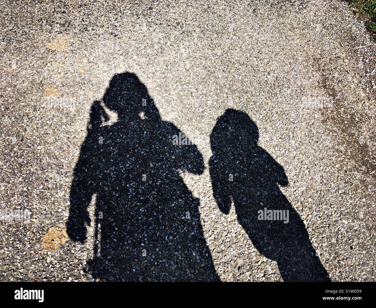 The shadows of a father and a son walking - Smartphone Captured Stock Image