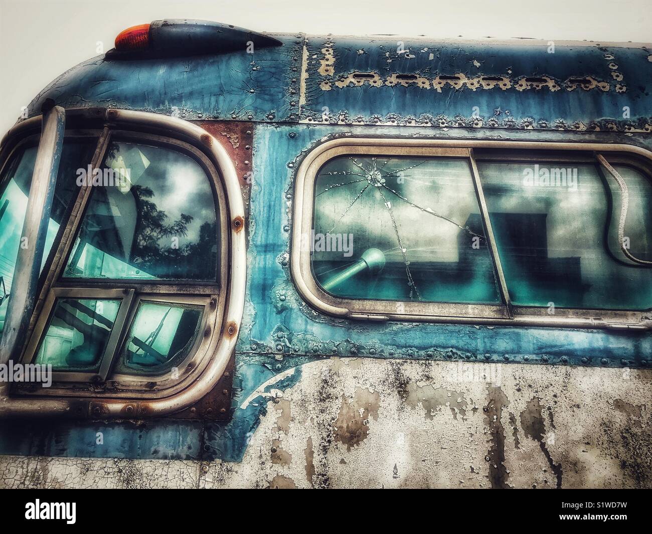 Rusty old abandoned blue and white passenger bus - Smartphone Captured Stock Image
