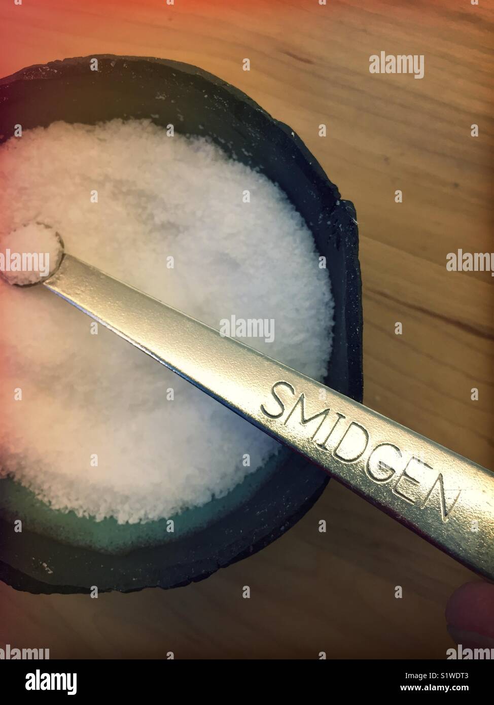 Smidgen measuring spoon in salt cellar, United States - Smartphone Captured Stock Image
