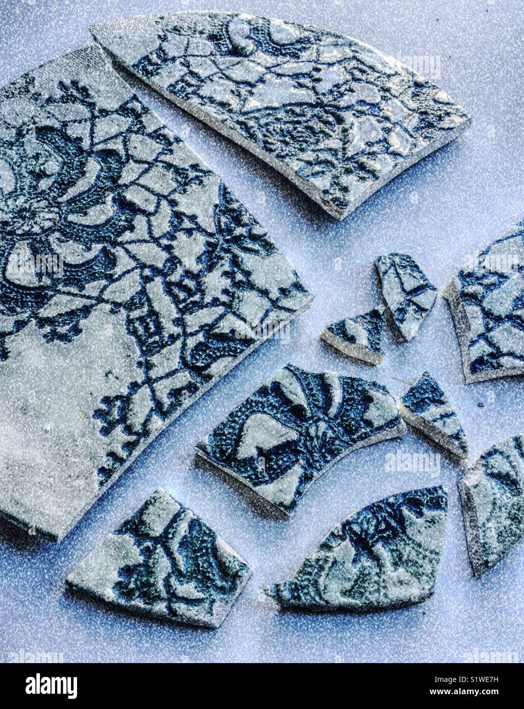 Broken hand thrown lace pattern pottery plate - Smartphone Captured Stock Image