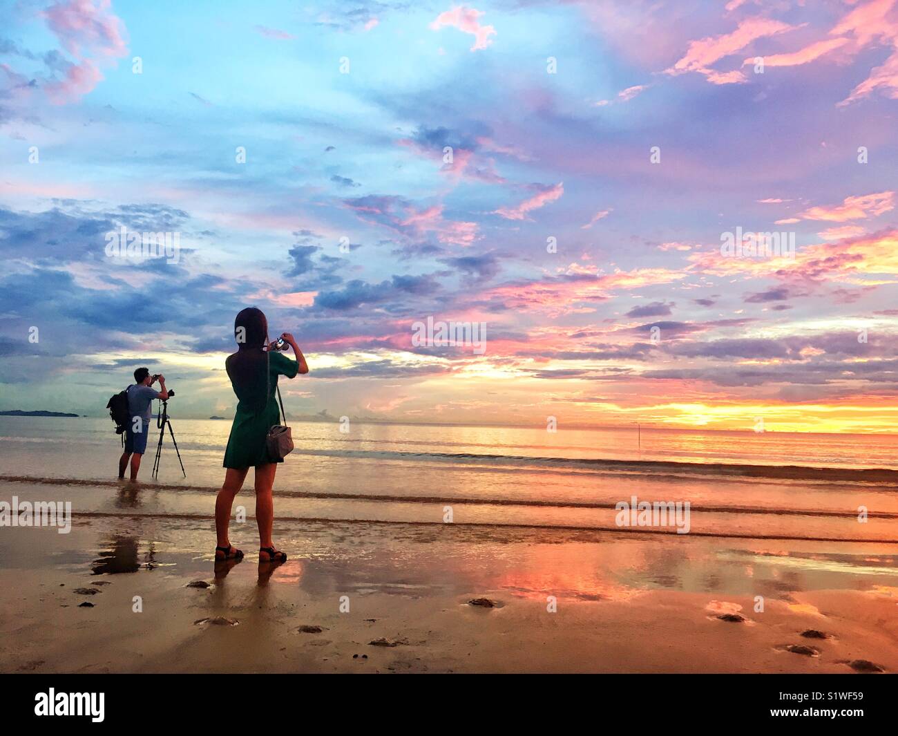 Tourists taking sunset photos Stock Photo