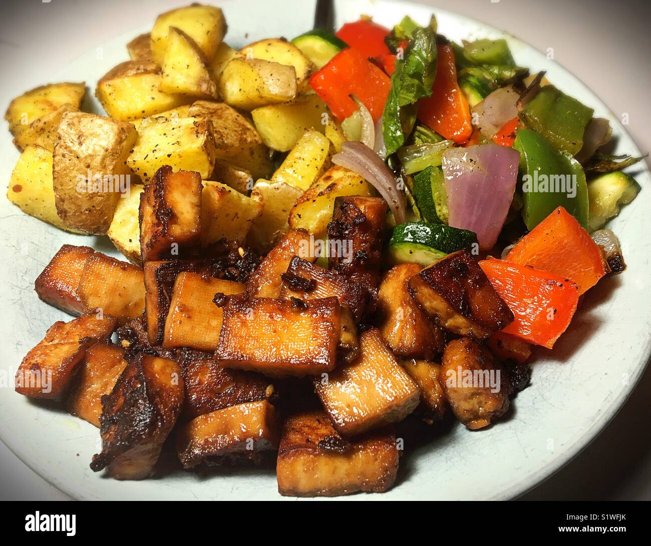 A vegan meal of tofu and grilled vegetables. Stock Photo