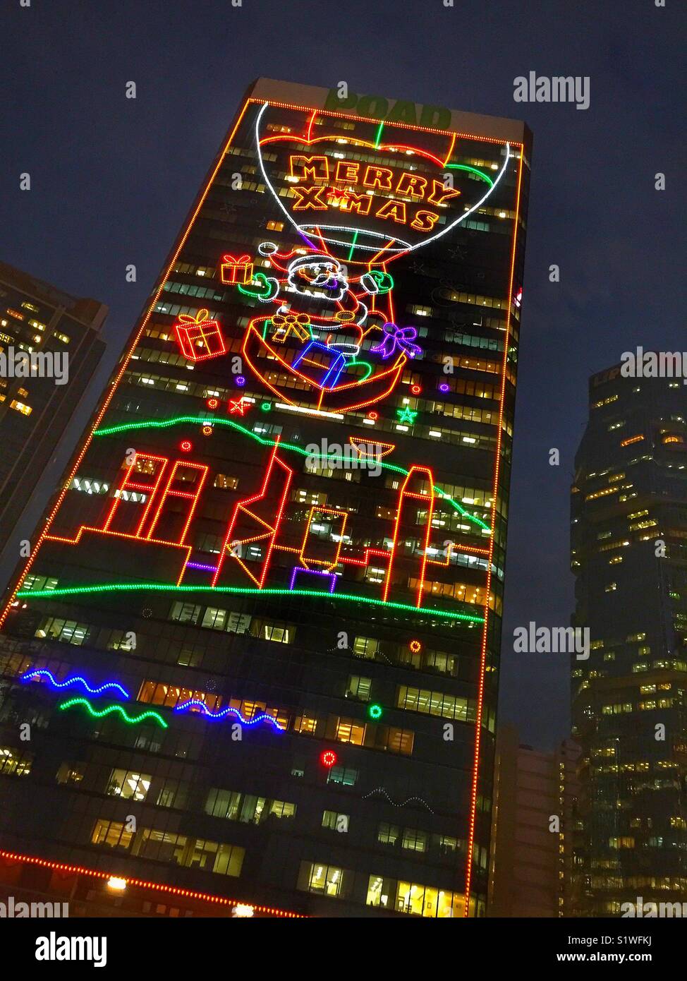 Decorative Christmas lighting on a high-rise office building in Admiralty, Central, Hong Kong - Smartphone Captured Stock Image
