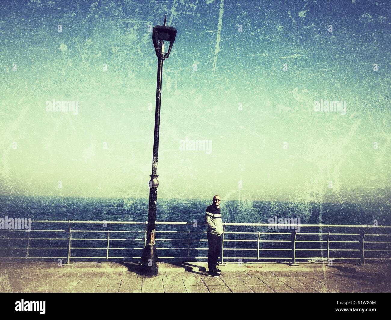 Man on the promenade turned back his face - Smartphone Captured Stock Image