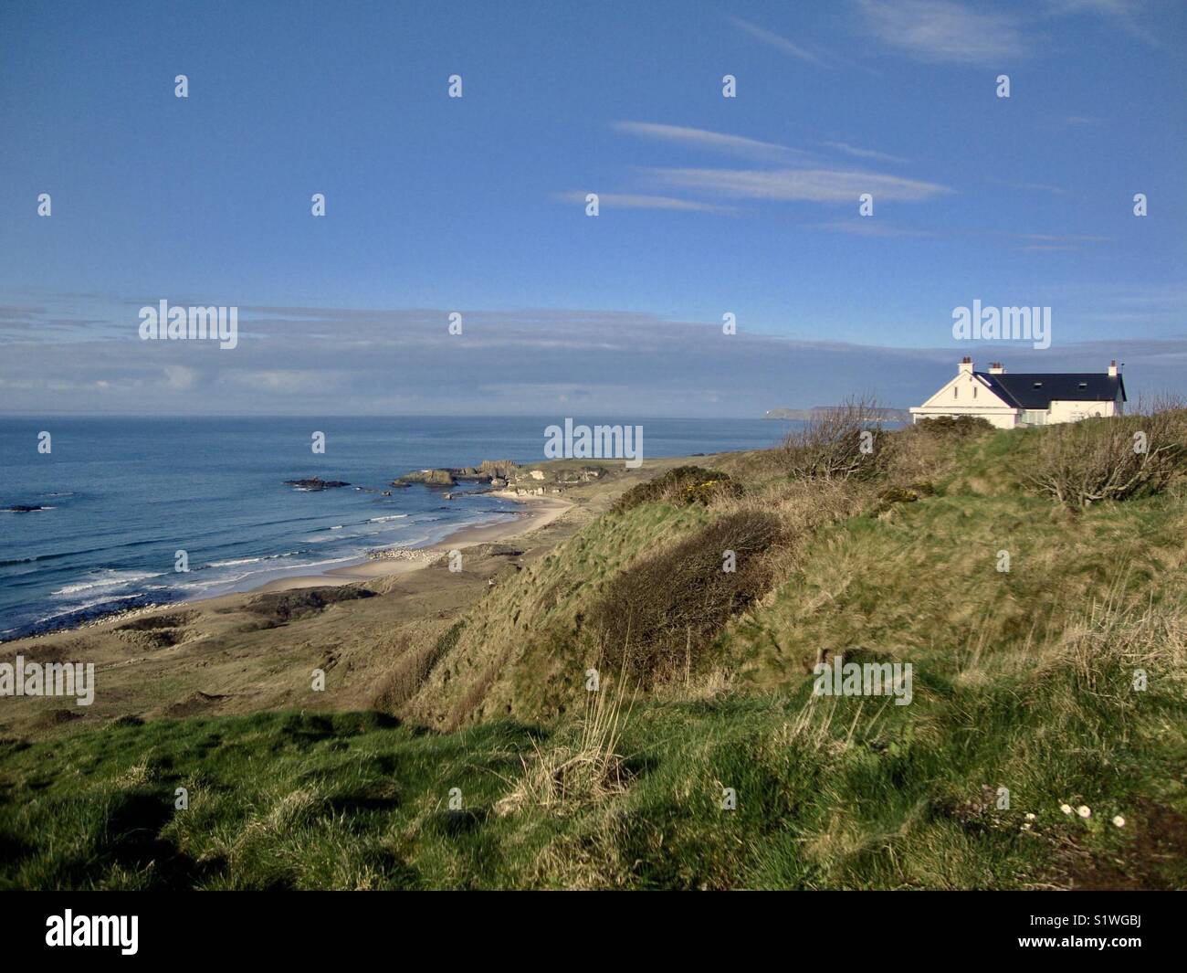 House on hilltop near Northern Ireland coastal area Stock Photo