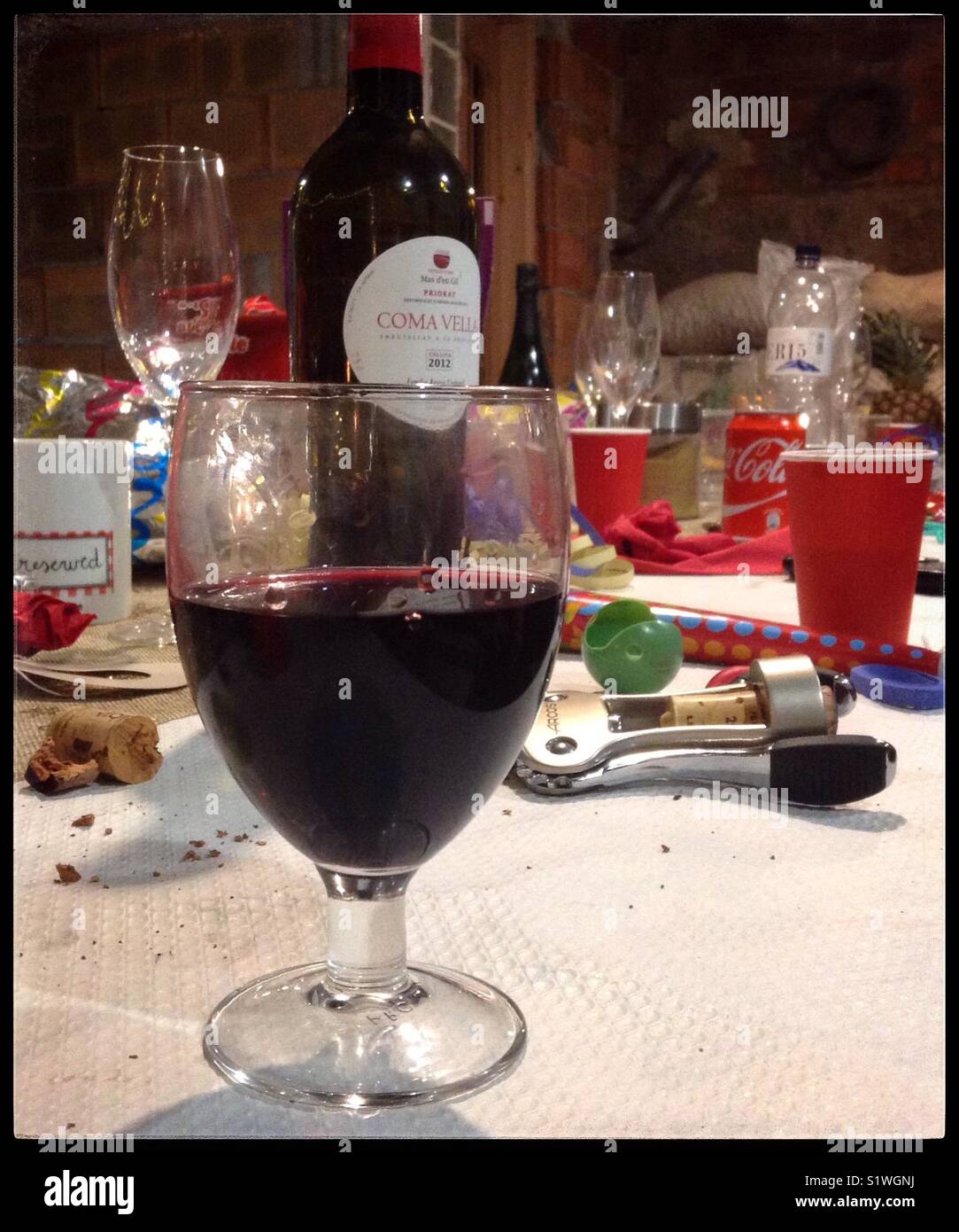 A glass of red wine at a Christmas party. - Smartphone Captured Stock Image