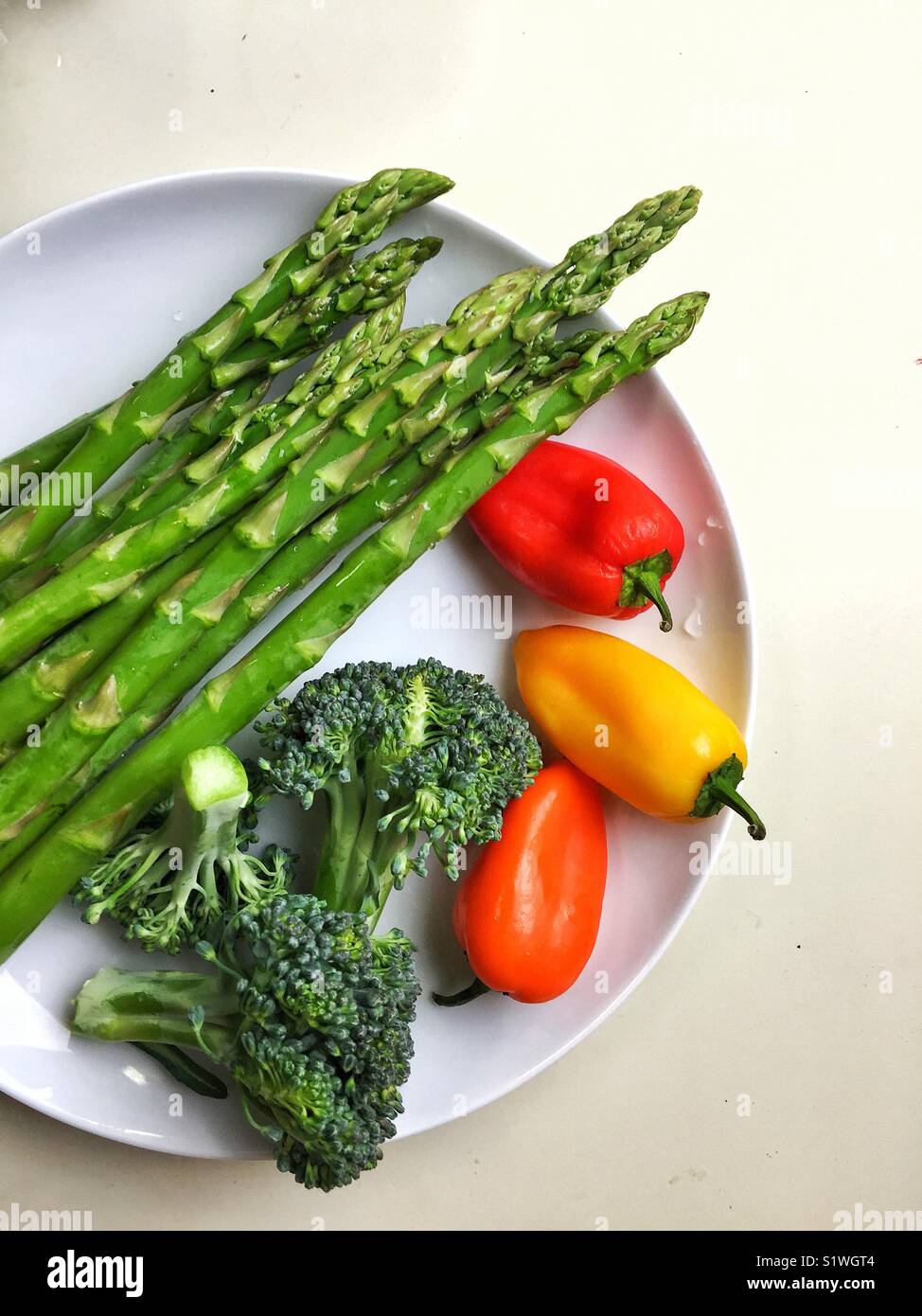 Healthy colorful veggies on white plate Stock Photo
