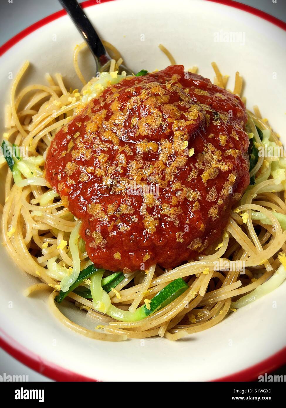 A bowl of capellini with zucchini noodles and marinara sauce Stock ...