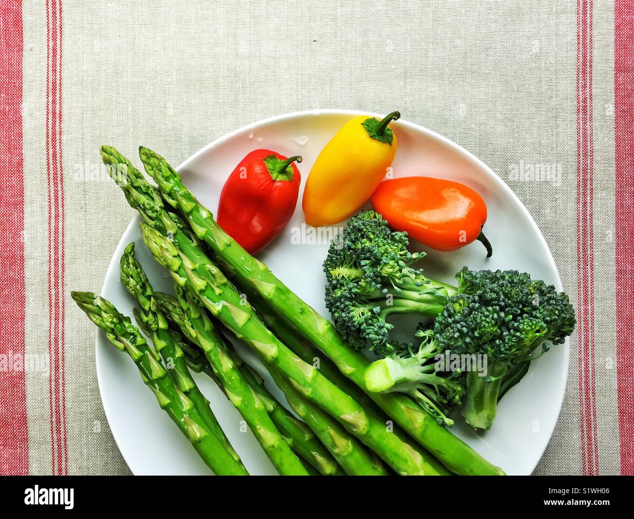 Healthy colorful veggies on white plate Stock Photo