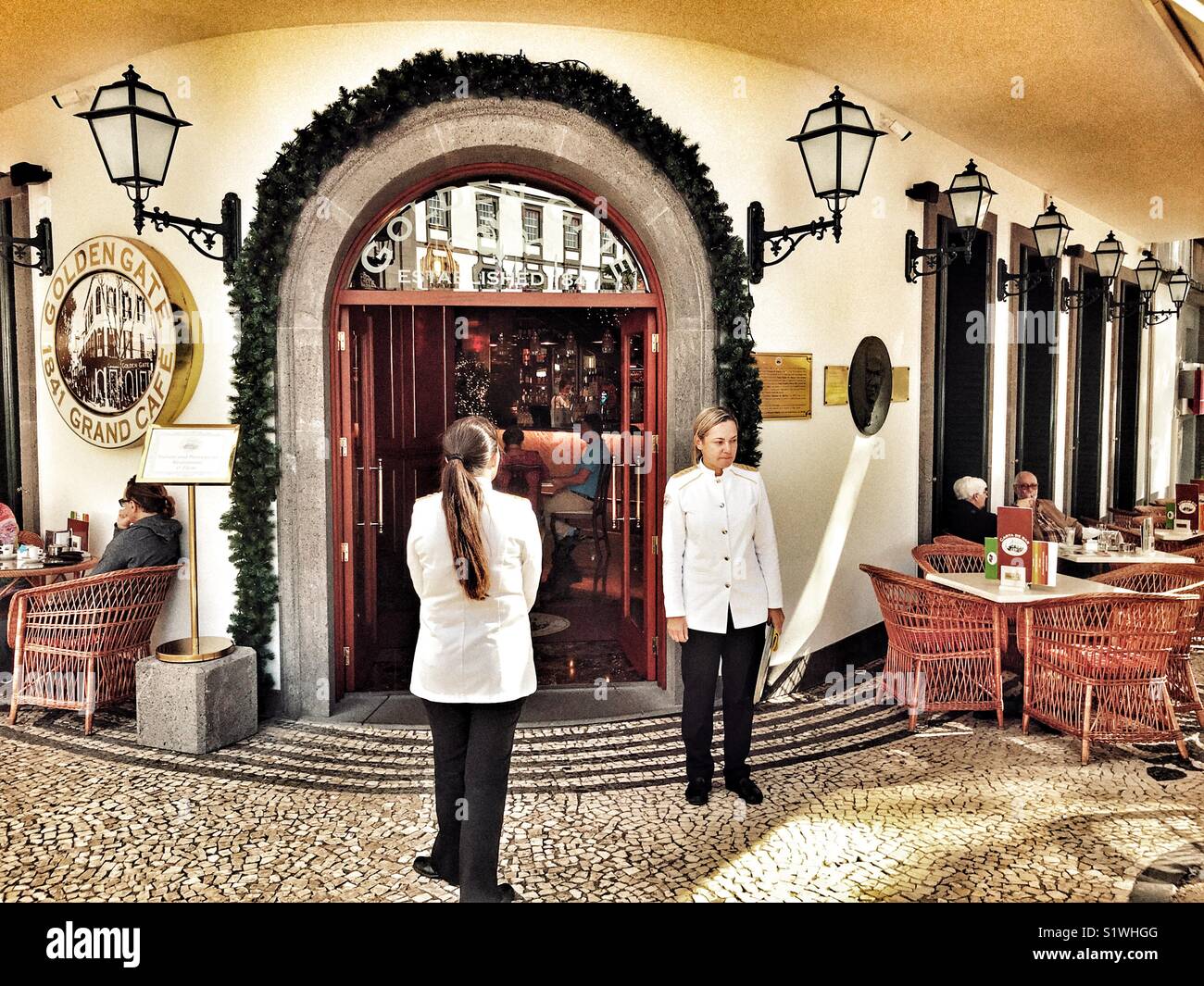 Waitresses outside the recently refurbished Golden Gate Grand Cafe on Avenida Zarco, Funchal, Madeira, Portugal - Smartphone Captured Stock Image