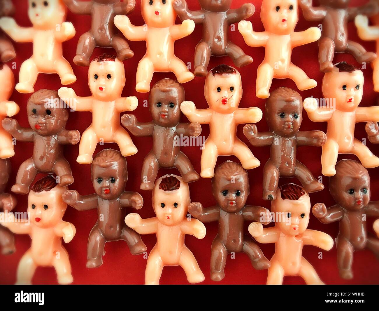 Rows of tiny plastic babies. Stock Photo