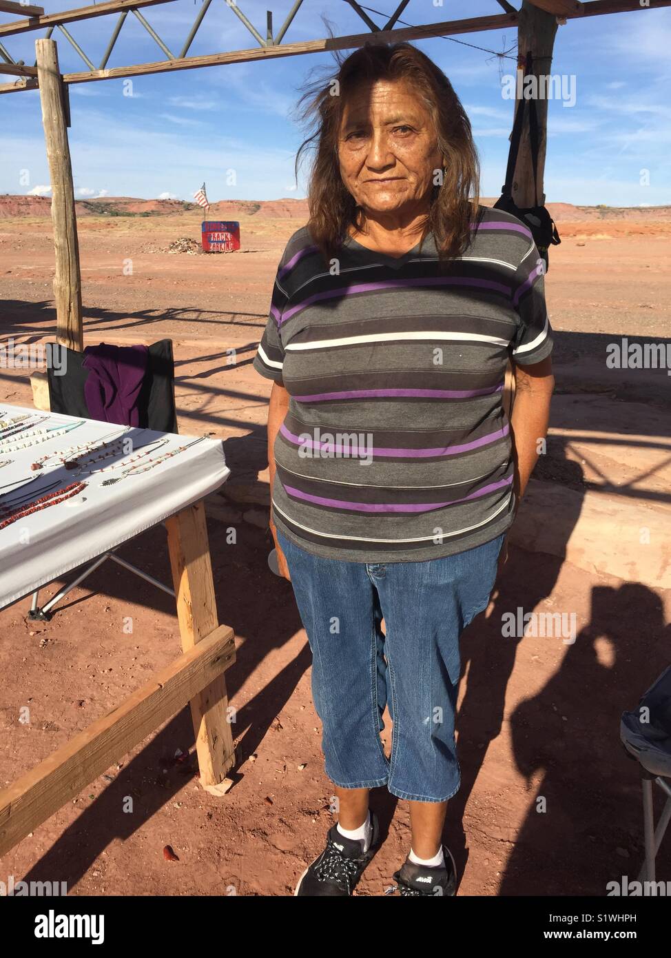 Juanita, Navajo Native American woman. She works as a tour guide of fossilized dinosaur tracks and sells her handmade jewelry in northern Arizona, USA. - Smartphone Captured Stock Image