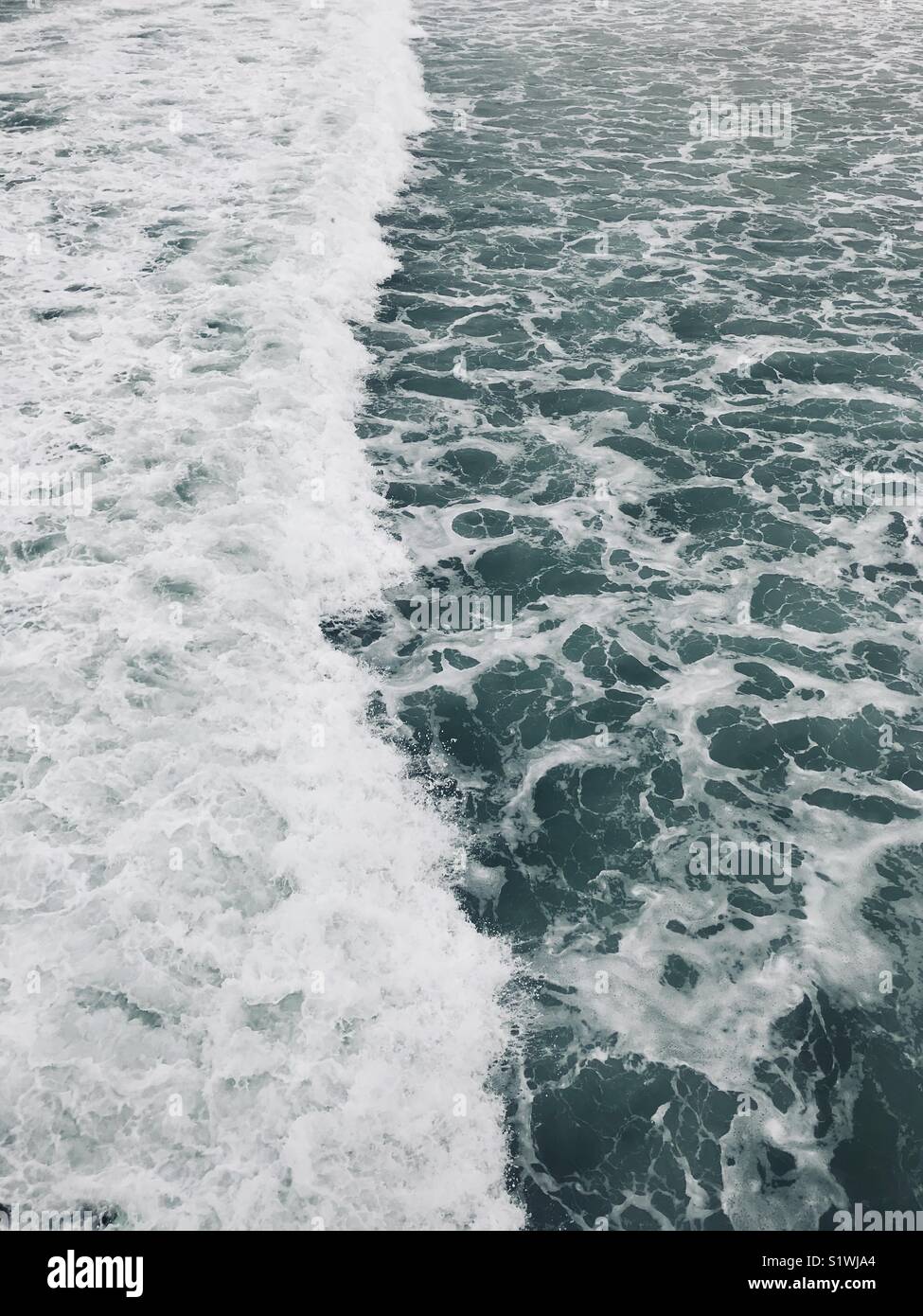 White water from a wave at the beach. Manhattan Beach, California USA. - Smartphone Captured Stock Image