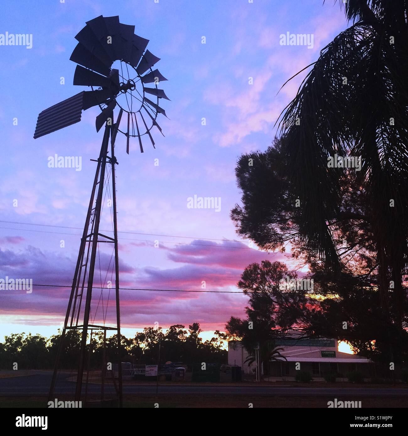 Windmill at sunset in the Australian outback Stock Photo Alamy