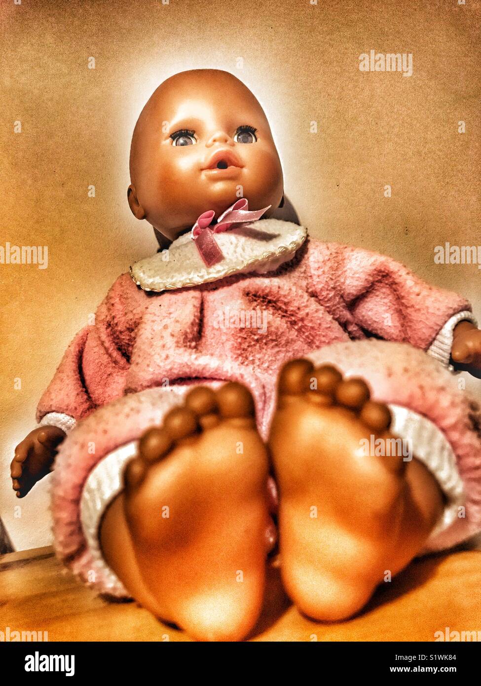 Baby doll on a shelf Stock Photo