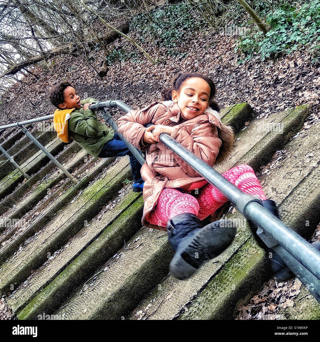 Kids playing on a handrail. - Smartphone Captured Stock Image