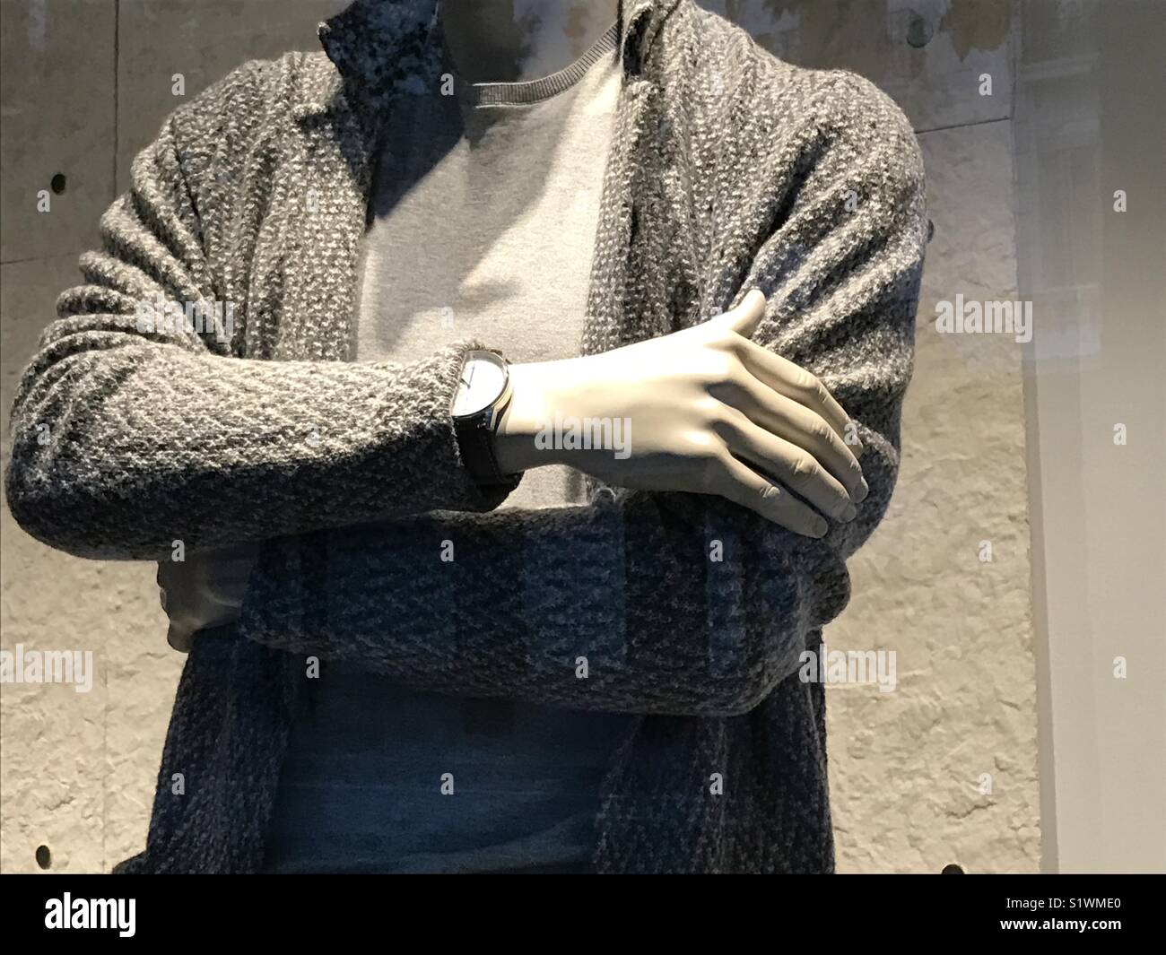 Mannequin crossing arms in a shop window. - Smartphone Captured Stock Image