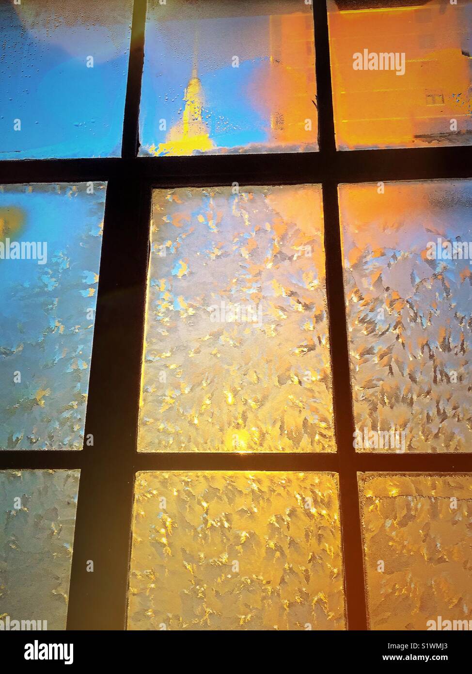 View of the Empire State building from New York City apartment with ice encrusted casement window, USA - Smartphone Captured Stock Image