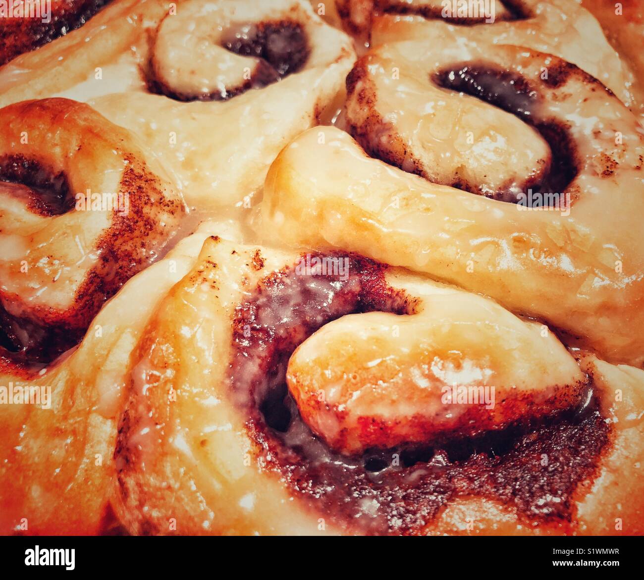 Freshly baked and glazed cinnamon roll buns closeup - Smartphone Captured Stock Image