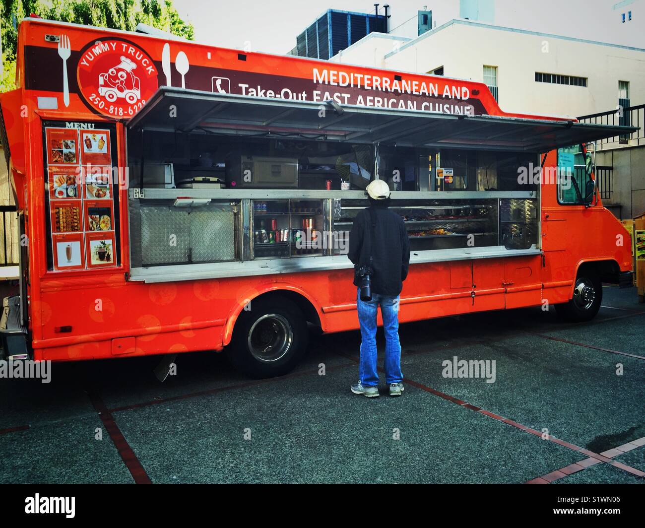 Male tourist waiting for his order near food truck in Victoria, BC Stock Photo