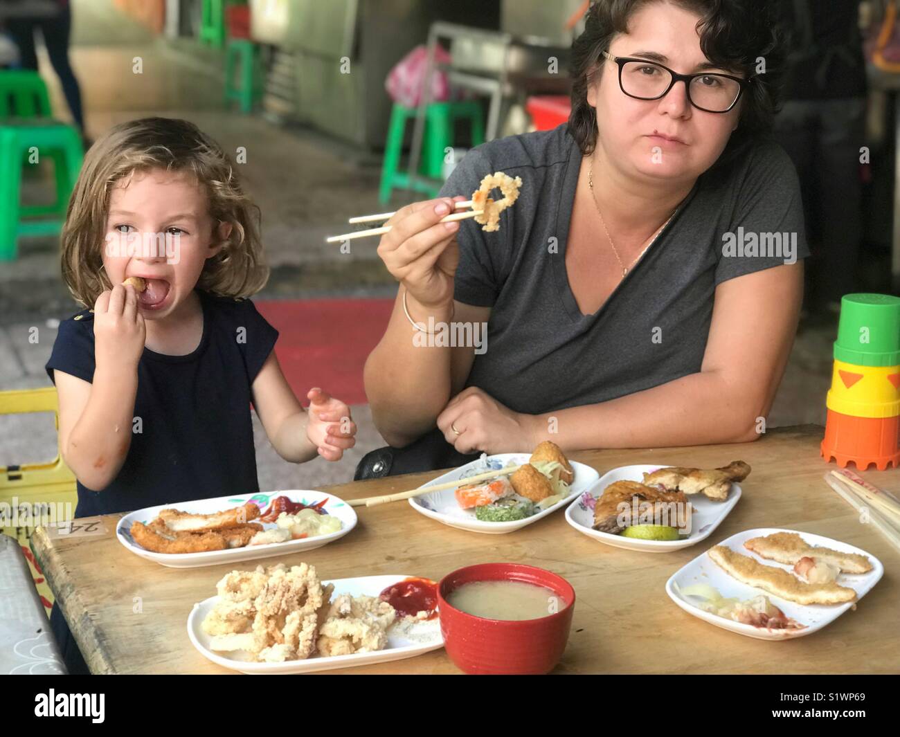 Mother and daughter eating together a Japanese food - Smartphone Captured Stock Image