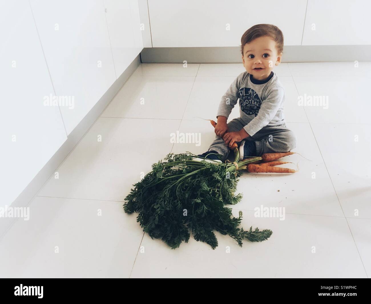 A toddler discovers carrots Stock Photo Alamy