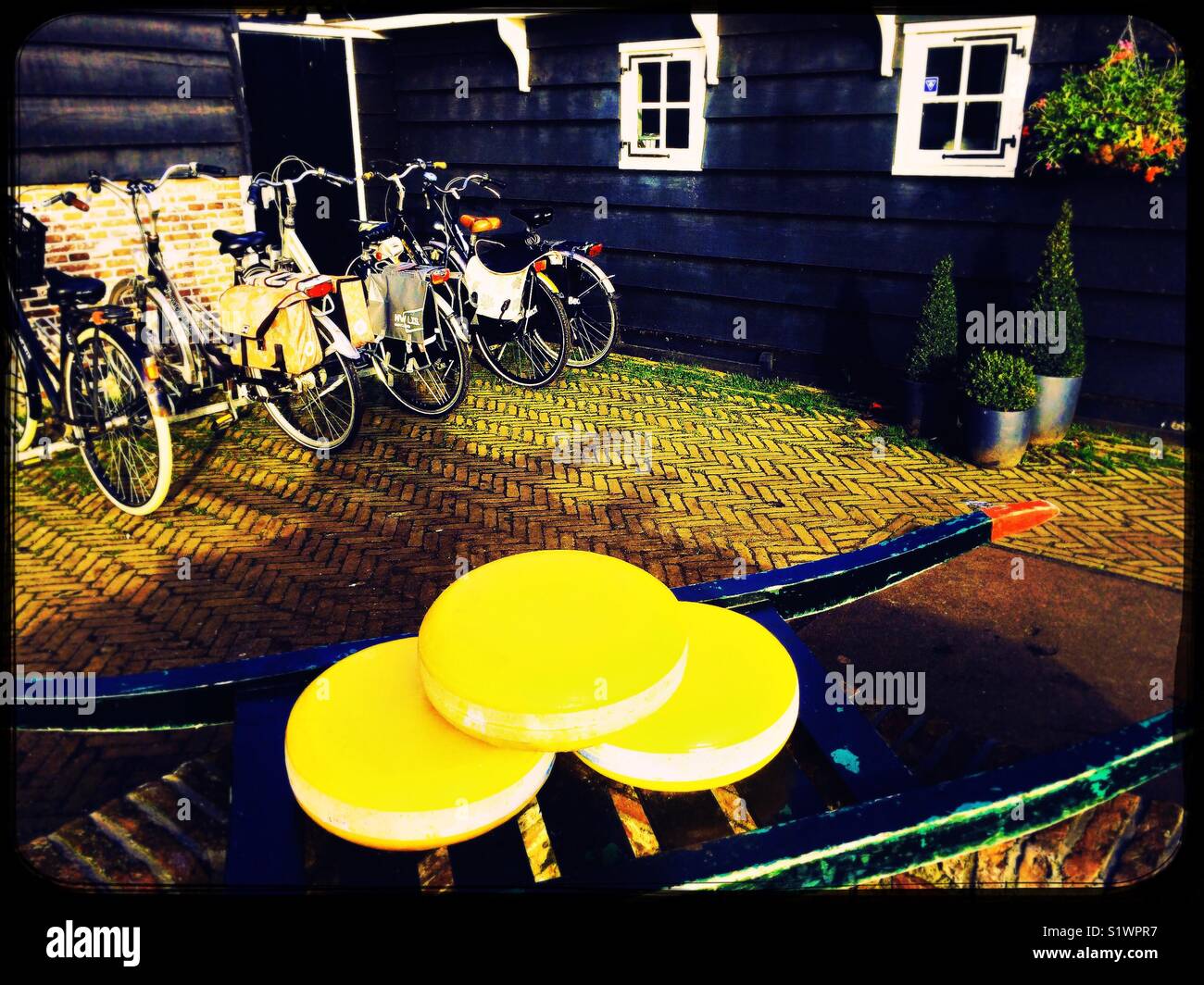 Whole cheeses displayed on barrow and bicycles, Netherlands - Smartphone Captured Stock Image