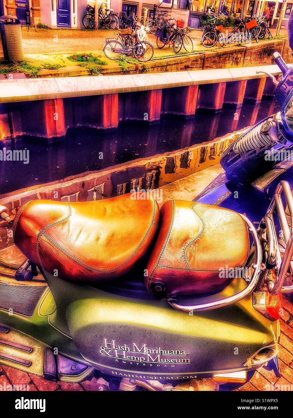 Motorbike with advertising for the Hash Marijuana & Hemp Museum, red light district, (De Wallen), Amsterdam, Netherlands - Smartphone Captured Stock Image