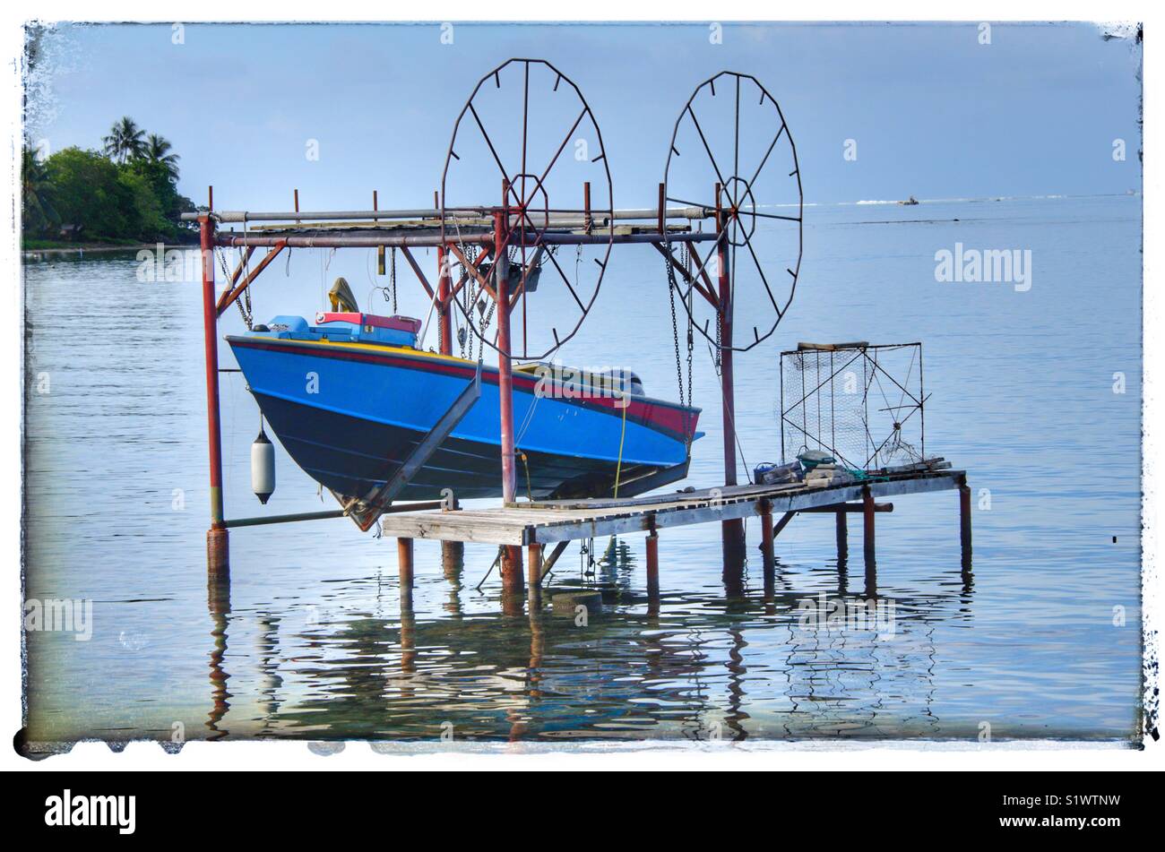 Fishing boat hanging over the water in BoraBora, French Polynesia