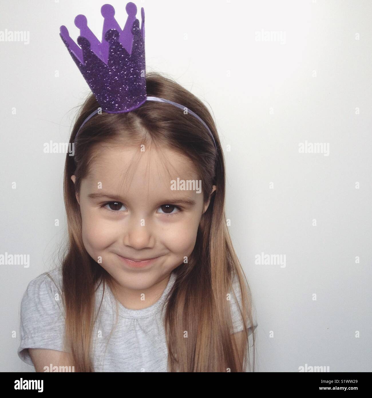 Little girl wearing glitter crown headband Stock Photo Alamy