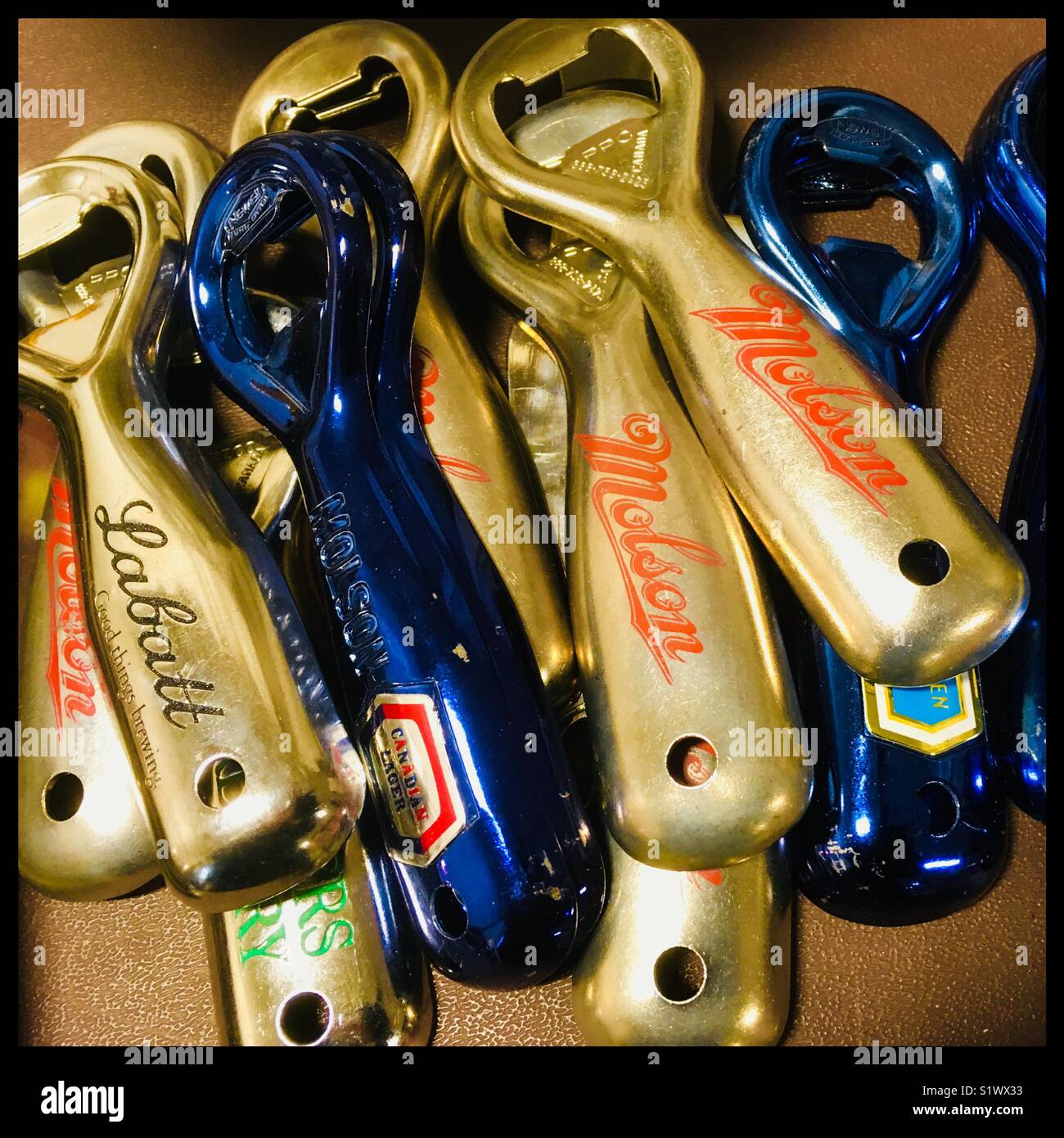 Vintage bottle opener with beer brands Stock Photo - Alamy