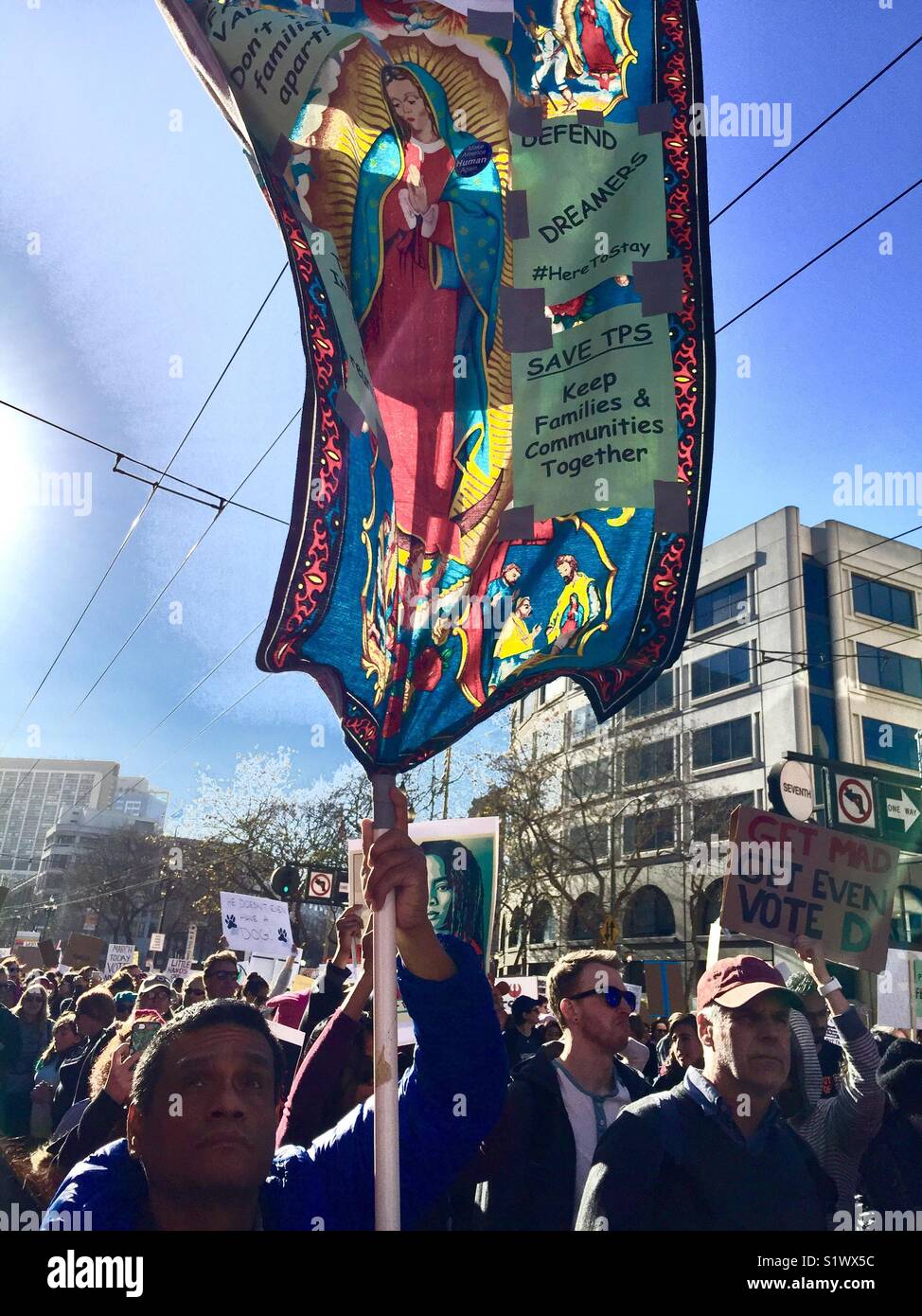 Protester holding sign of Our Lady of Guadalupe at Women's March 2018, San Francisco, CA, USA. - Smartphone Captured Stock Image