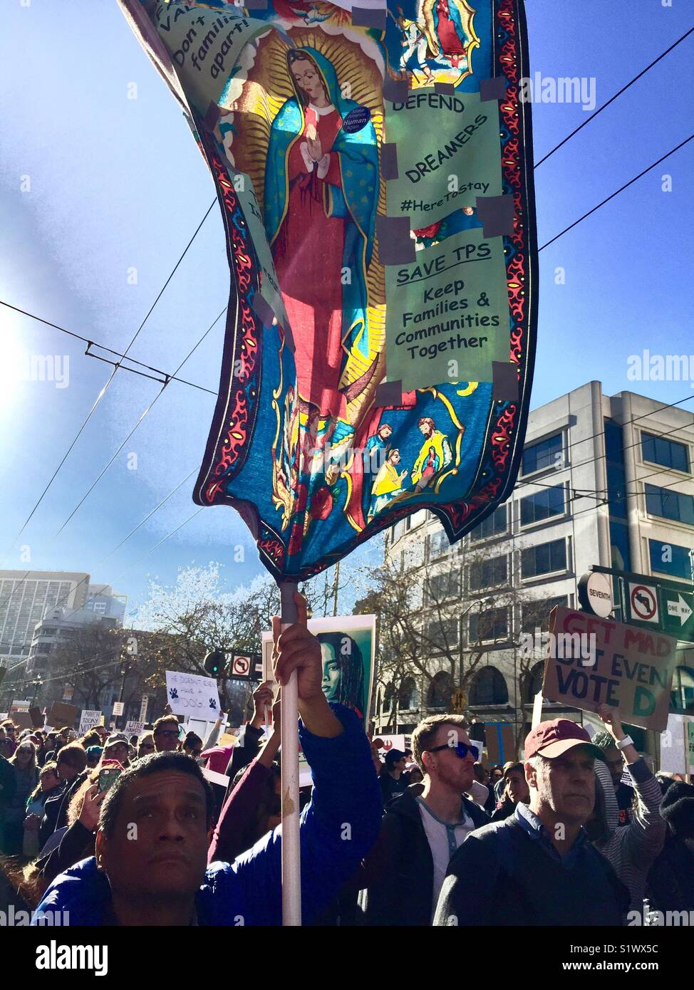Protester holding sign of Our Lady of Guadalupe at Women's March 2018, San Francisco, CA, USA. Stock Photo