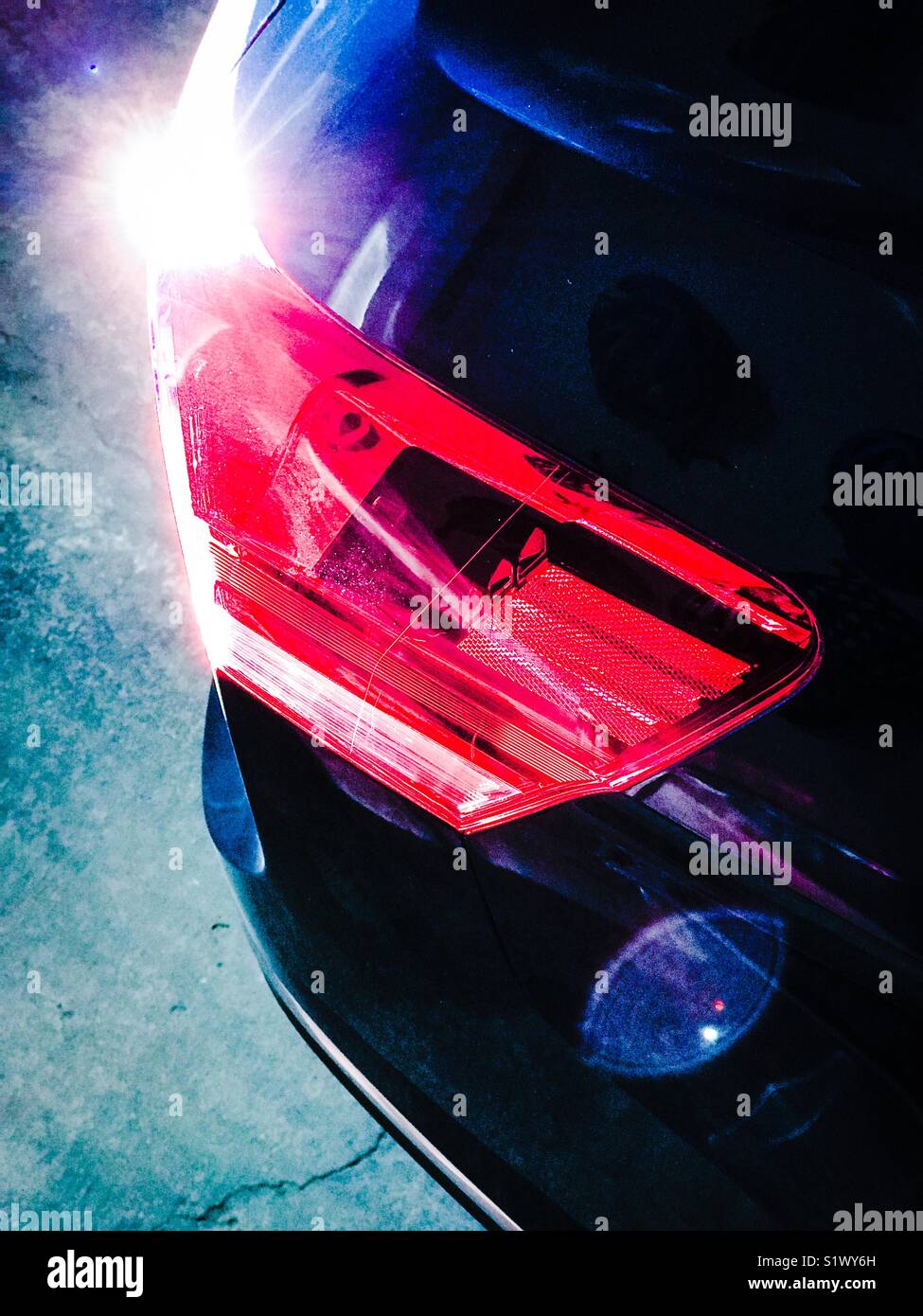 Tail light on a dark blue car Stock Photo Alamy
