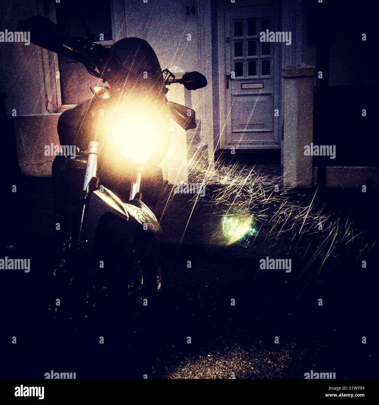 Rain falling lit by a motorcycle headlight - Smartphone Captured Stock Image