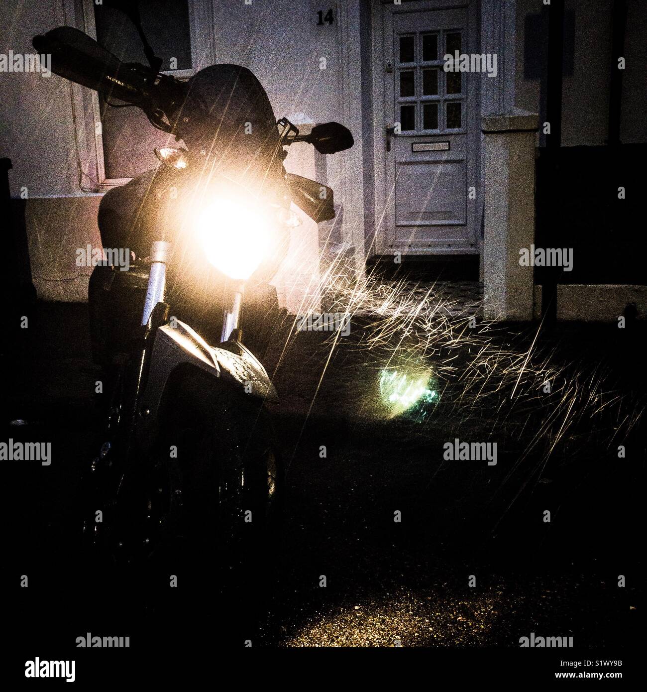 Rain falling lit by a motorcycle headlight - Smartphone Captured Stock Image
