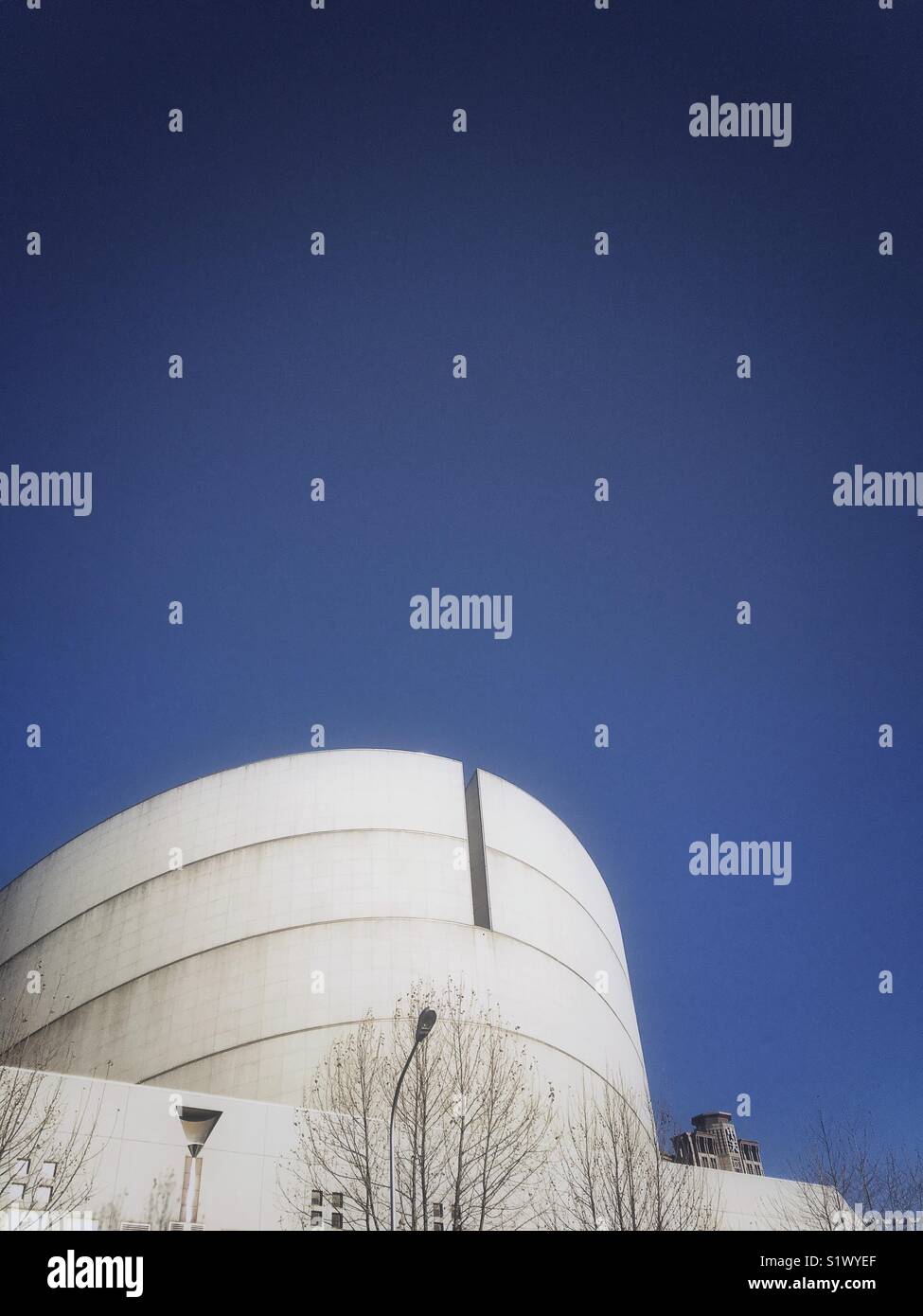Top of round building against blue sky - Smartphone Captured Stock Image