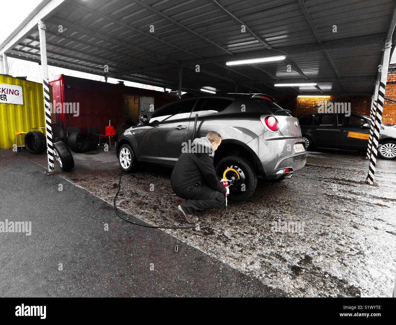Changing A Spare Tyre At A Motor Garage Stock Photo Alamy