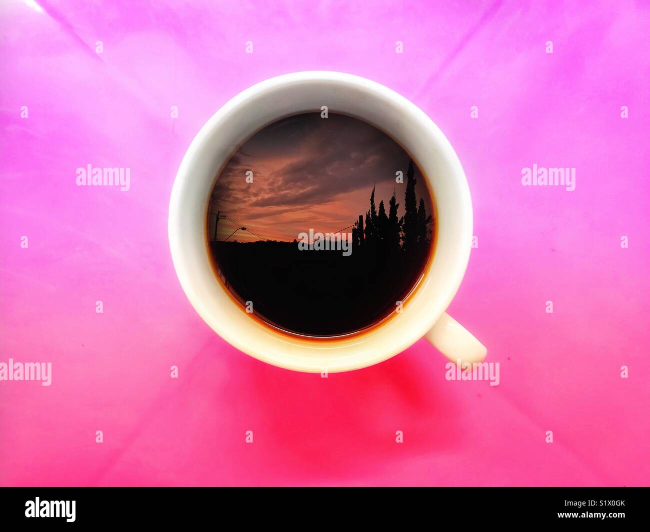 Cup of coffee seen from directly above with a silhouette of a horizon in the cup - Smartphone Captured Stock Image