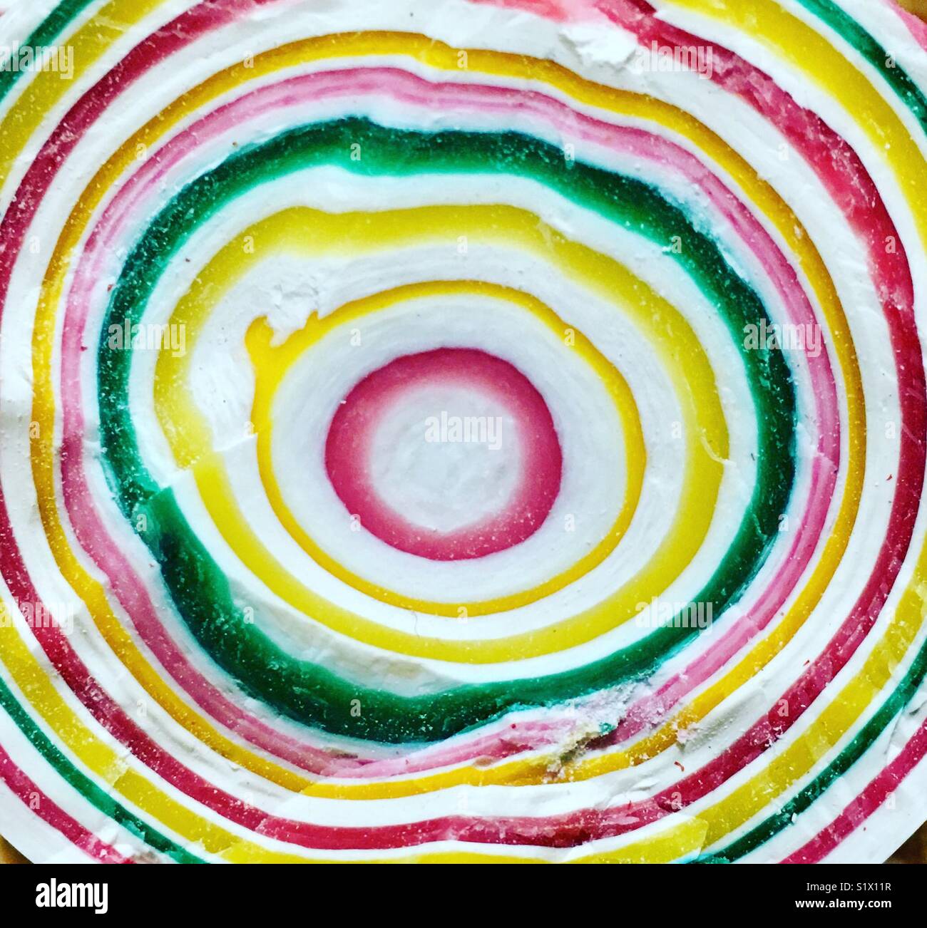 Split Gobstopper sweet showing colourful ring pattern. Stock Photo