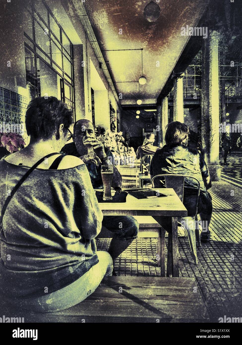 Couple at a cafe in the Mercado dos Lavradores, Funchal, Madeira, Portugal - Smartphone Captured Stock Image