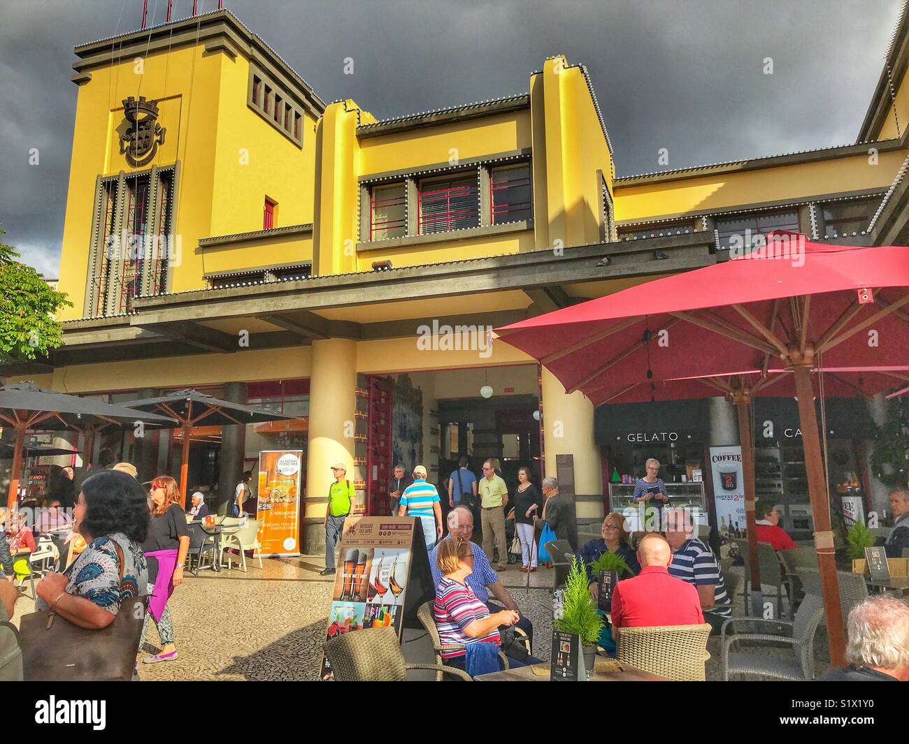 STreet scene with people at a cafe outside the Mercado dos Lavradores, Funchal, Madeira, Portugal - Smartphone Captured Stock Image